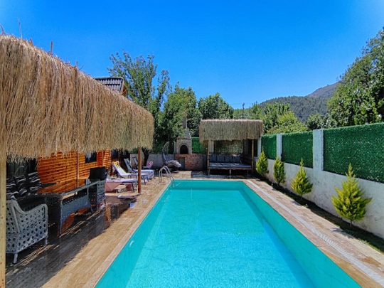 Fethiye Kayaköy'de yer alan Villa Dream 1'in geniş özel havuzu, güneşlenme alanı ve muhafazakâr bahçesi.