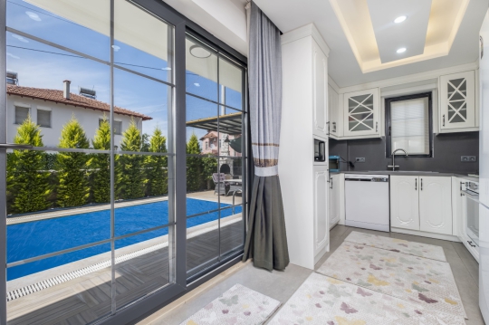 Fethiye’deki Çisem 3 Villa’nın salonundan özel havuz alanına açılan geniş sürgülü cam kapılar.