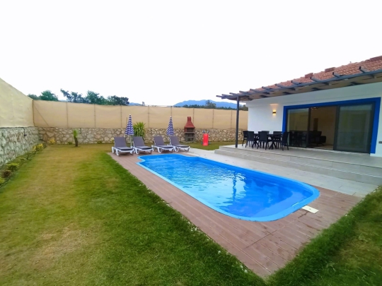 Villa Elmas 2’nin geniş özel havuzu ve korunaklı bahçe yapısıyla huzurlu yaz tatili imkanı.
