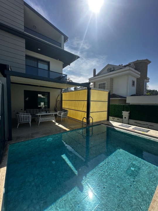 Villa Menteş 2’nin özel yüzme havuzu ve geniş bahçe alanı ile ailelere uygun konforlu tatil villası görünümü.