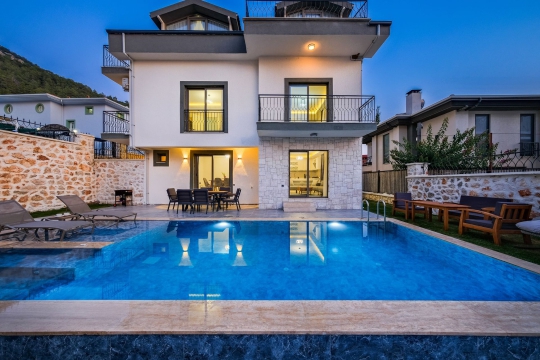 Villa Rita 1 Faralya’da geniş özel yüzme havuzu, modern mimarisi ve havuz başı dinlenme alanıyla aile tatil villası.