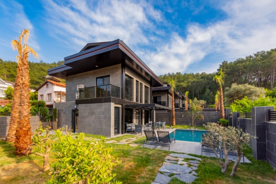 Fethiye Göcek'te doğa manzaralı, geniş çim bahçeli ve özel yüzme havuzlu 2 katlı lüks Villa Anka 3'ün genel dış cephe görünümü.