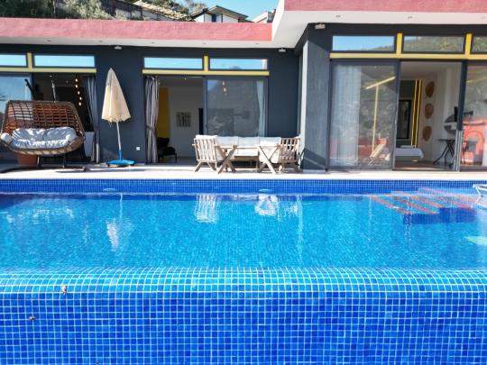 Villanın modern dış cephesi ile havuzun birleştiği şık açı.