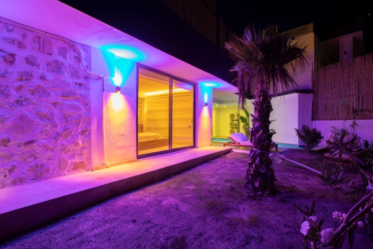 Renkli LED aydınlatmalı havuz terası ve çim bahçe alanı