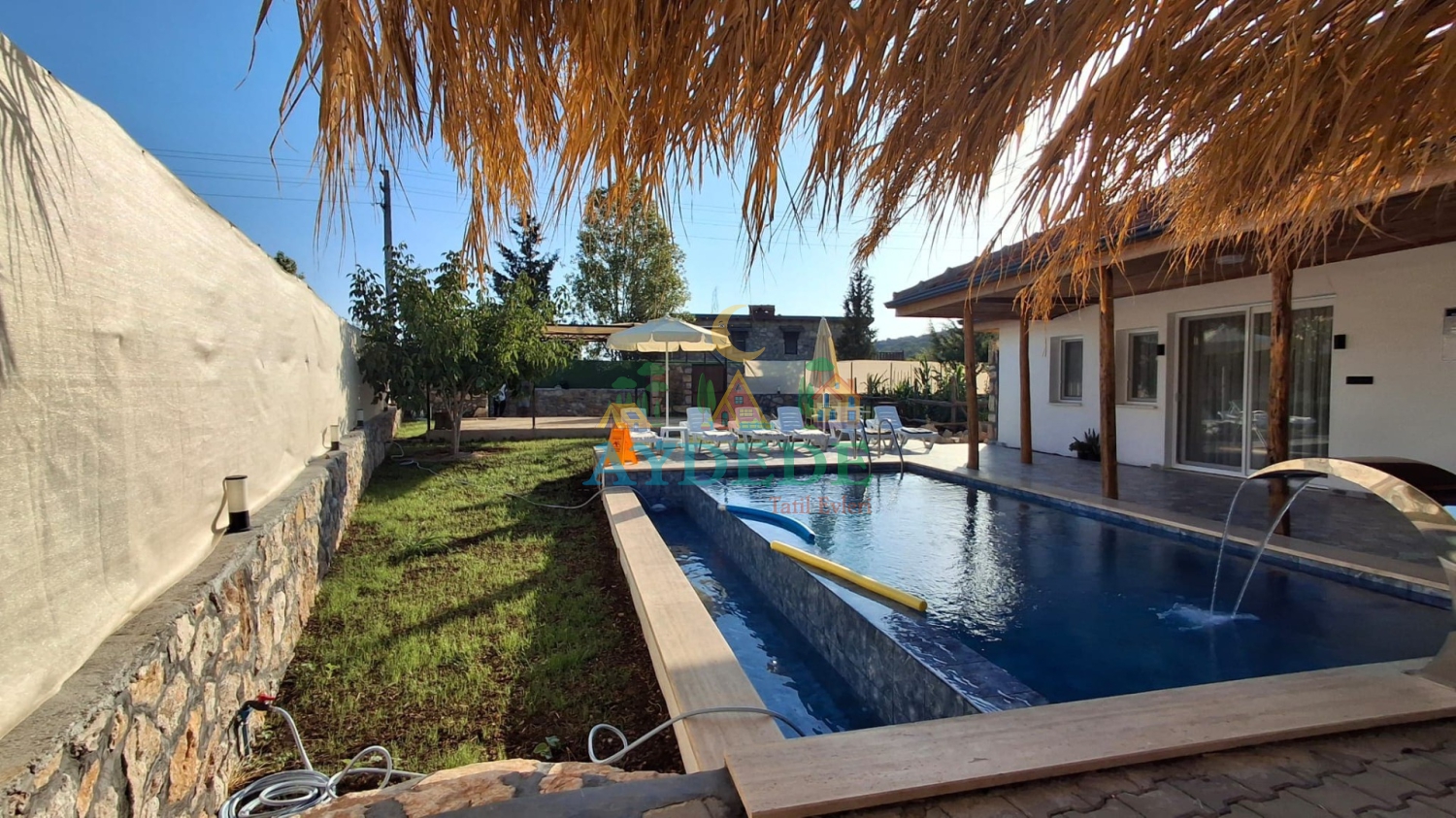 Fethiye’de özel havuzlu muhafazakar kiralık villa bahçesi ve geniş yüzme havuzu görünümü